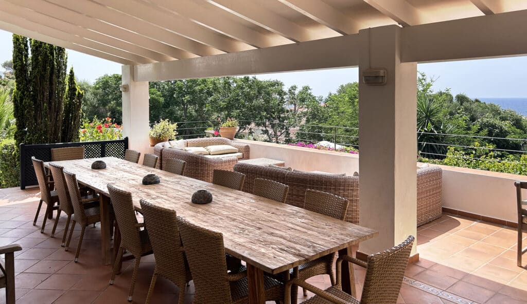 Outdoor dining terrace at La Calera villa in Binibeca Menorca with sea view